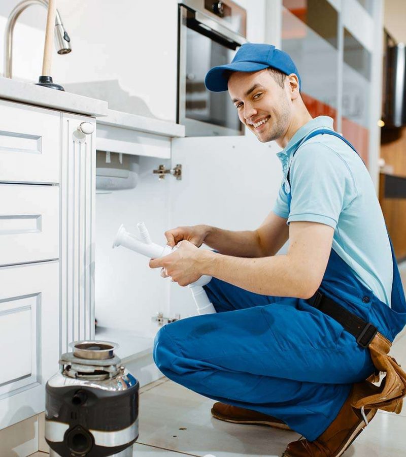smiling-male-plumber-in-uniform-holds-drain-pipe-resize.jpg smiling-male-plumber-in-uniform-holds-drain-pipe-resize.jpg